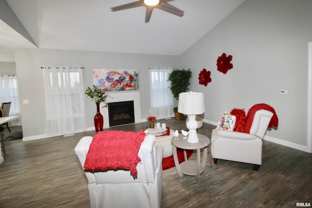 living room featuring ceiling fan, lofted ceiling, and dark hardwood / wood-style flooring