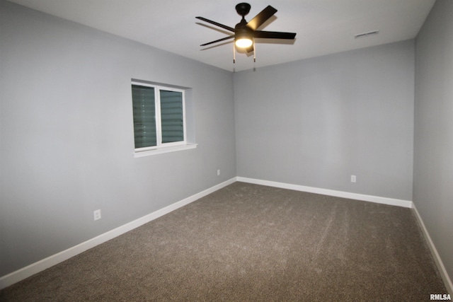 carpeted spare room featuring ceiling fan