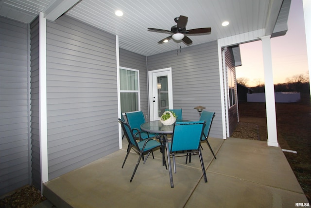 patio terrace at dusk featuring ceiling fan