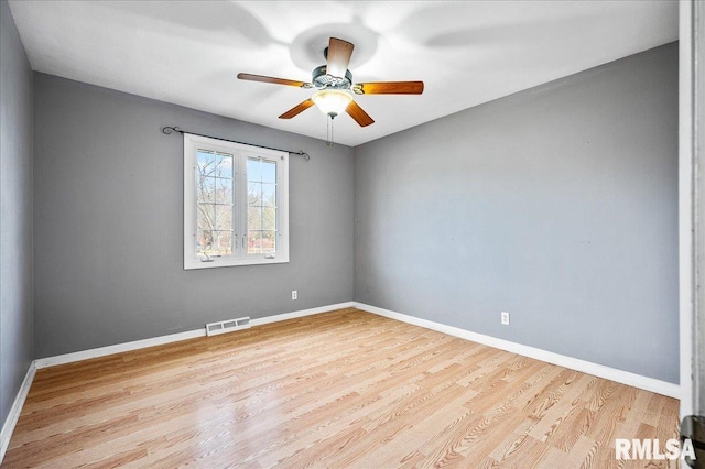 empty room featuring ceiling fan and light wood-type flooring