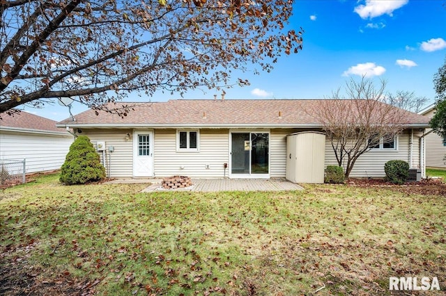 rear view of house featuring a lawn