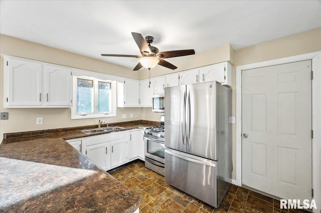 kitchen featuring stainless steel appliances, white cabinetry, sink, and ceiling fan