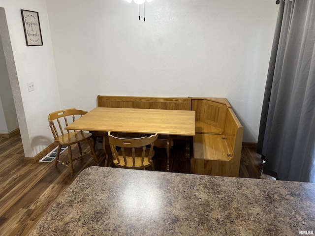 dining room with dark hardwood / wood-style floors and breakfast area