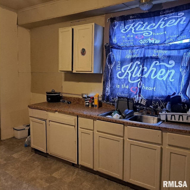 kitchen featuring sink and white cabinets