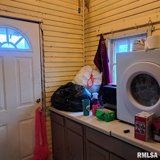 laundry area featuring washer / dryer and wooden walls