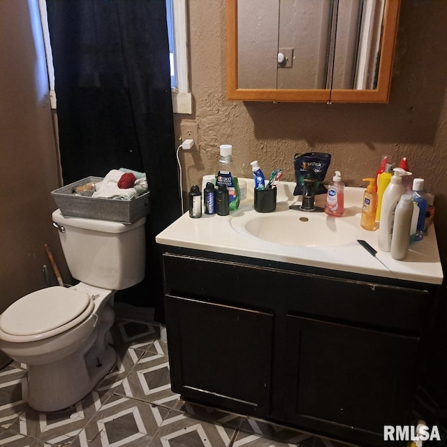 bathroom with vanity and toilet