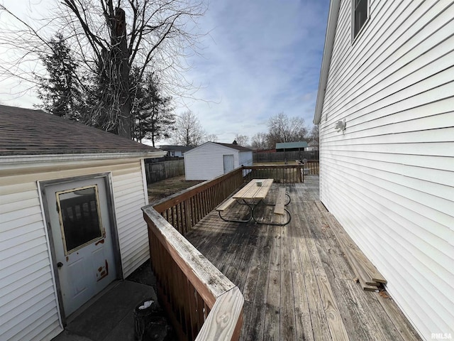 wooden terrace featuring an outdoor structure