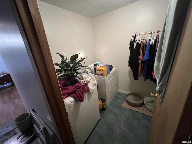 laundry area featuring washer and dryer and a textured ceiling