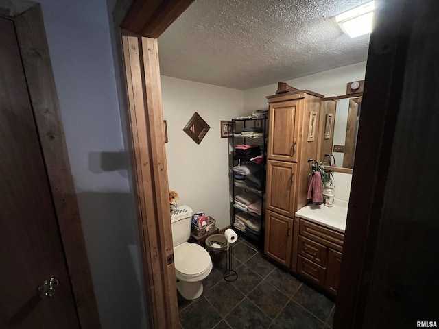 bathroom with tile patterned floors, toilet, and a textured ceiling