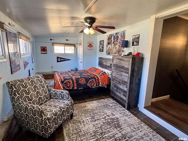 tiled bedroom featuring ceiling fan, wooden walls, and vaulted ceiling