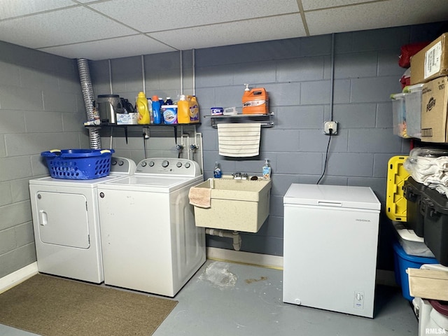 washroom featuring separate washer and dryer and sink