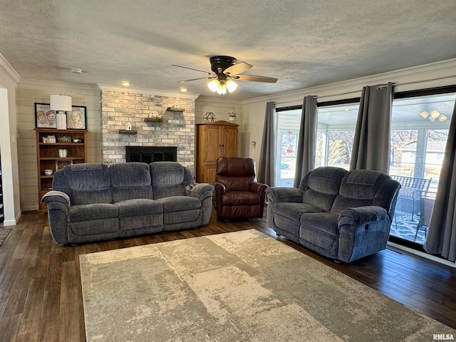 living room featuring a brick fireplace, crown molding, and dark wood-type flooring