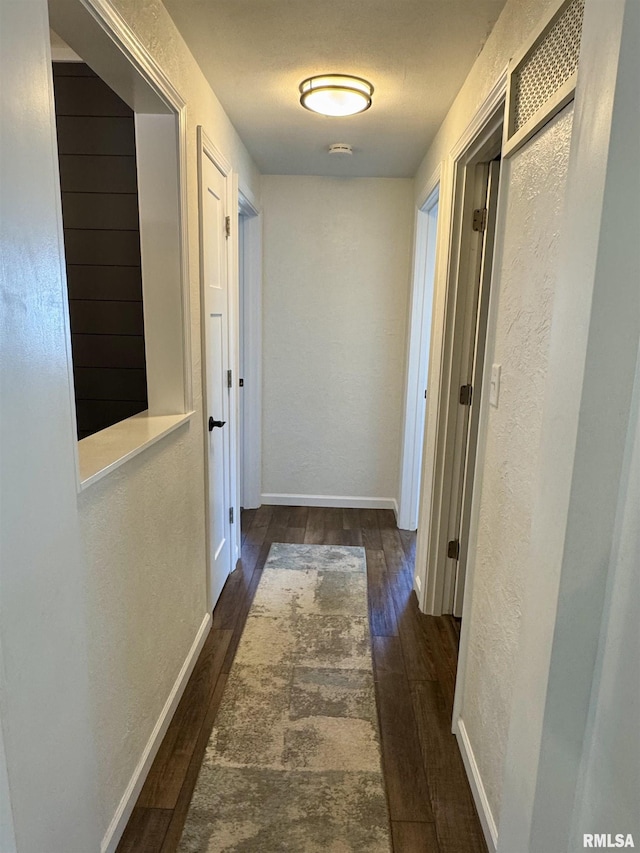 hall with dark wood-type flooring