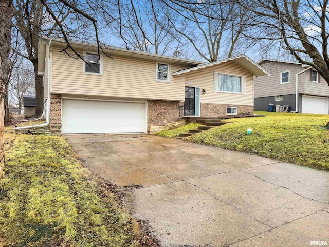 bi-level home with a garage and a front lawn