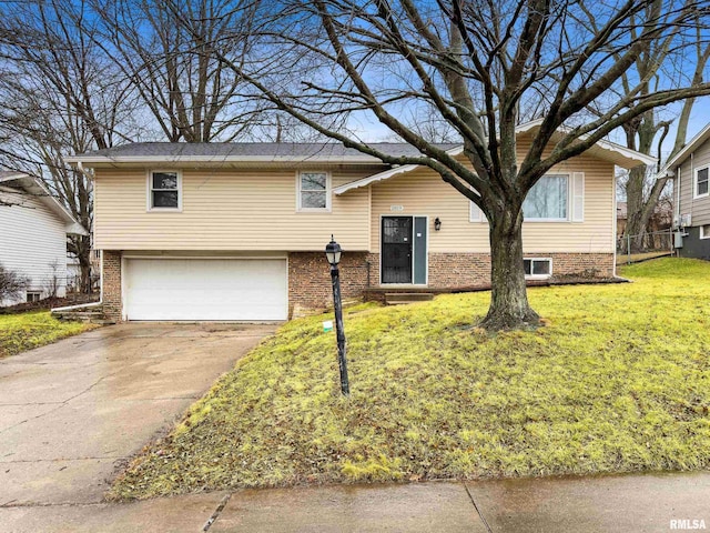 raised ranch with a garage and a front yard