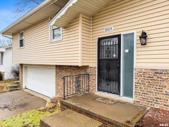 view of exterior entry with a garage