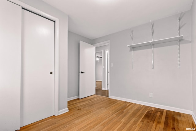 unfurnished bedroom with hardwood / wood-style floors and a closet