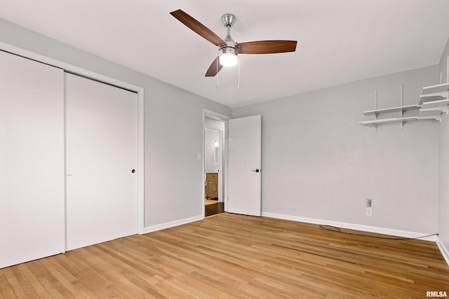 unfurnished bedroom with light hardwood / wood-style flooring, a closet, and ceiling fan