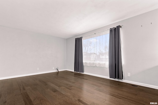 spare room with hardwood / wood-style flooring