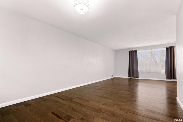 empty room featuring dark wood-type flooring