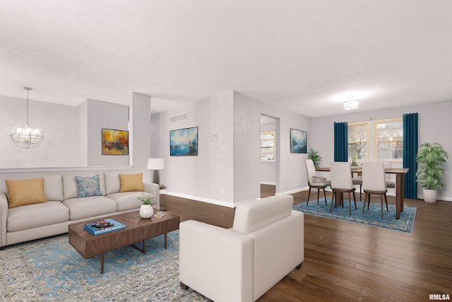 living room with hardwood / wood-style floors and a chandelier