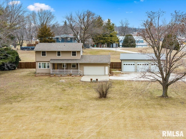 view of front of home featuring a garage, a front yard, and covered porch