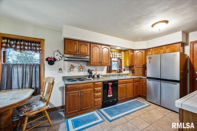 kitchen featuring dishwasher, stovetop, sink, stainless steel fridge, and light tile patterned floors