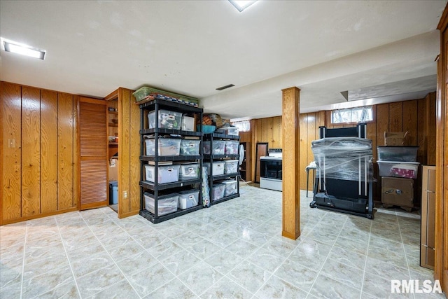 basement featuring wooden walls