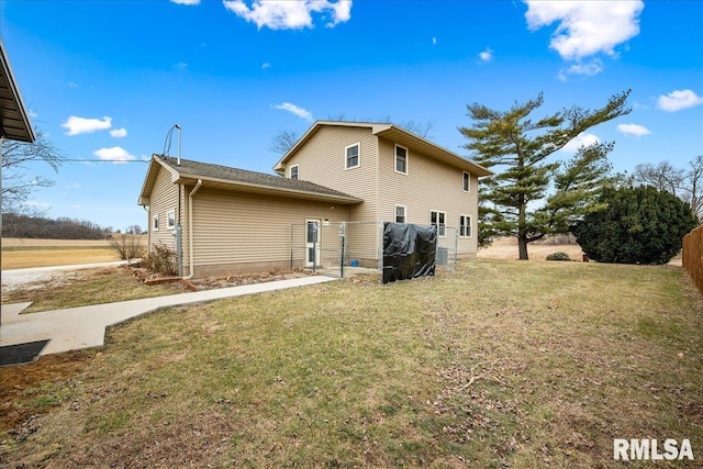 back of property with a lawn