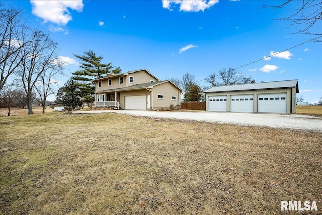 front of property featuring a porch, a garage, and a front lawn