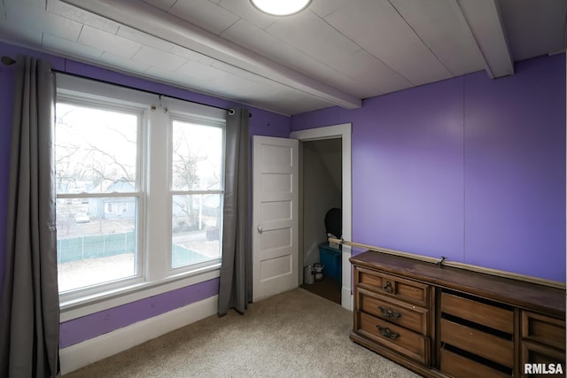 bedroom featuring multiple windows, carpet flooring, and beam ceiling