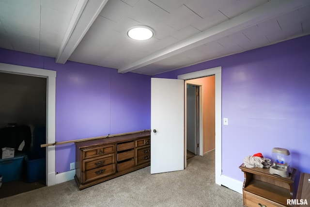 bedroom featuring beamed ceiling and light carpet