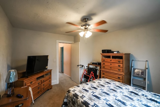 bedroom featuring light colored carpet and ceiling fan