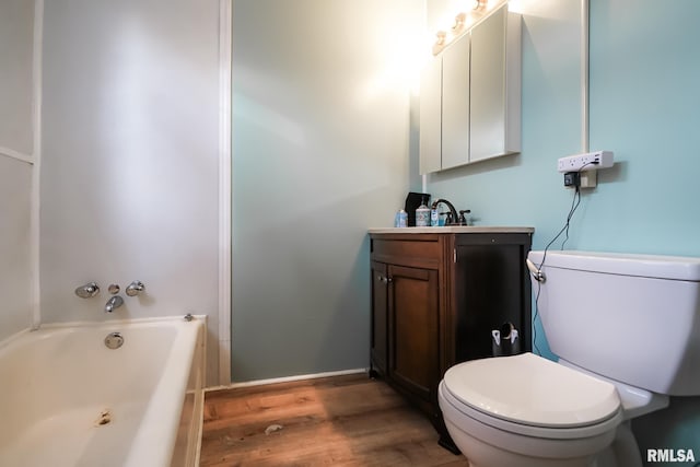 bathroom featuring vanity, hardwood / wood-style flooring, and toilet