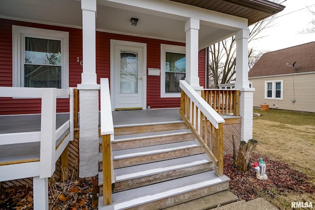 view of exterior entry with a porch