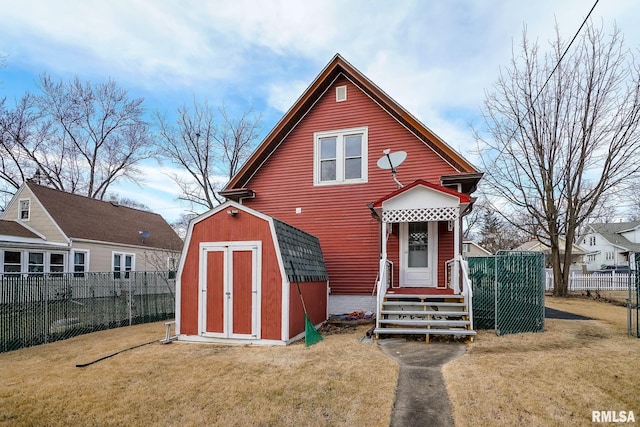 view of front of home featuring a storage unit and a front lawn