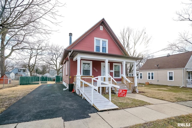 bungalow with a front yard and covered porch