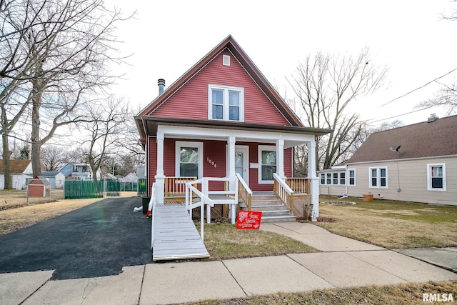 bungalow with a front yard and a porch