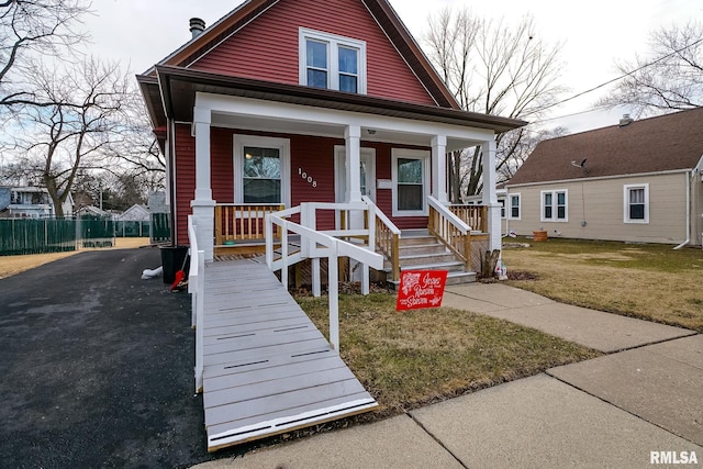 bungalow featuring a front yard and a porch