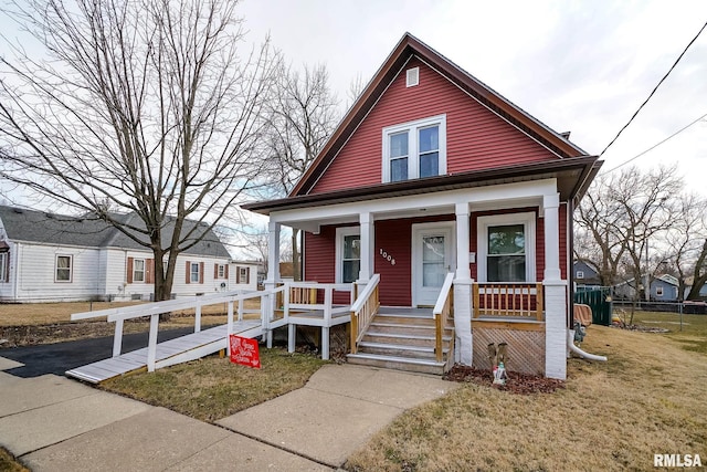 bungalow with a front lawn and covered porch