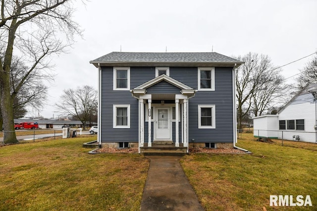 view of front of home featuring a shingled roof, a front yard, and fence