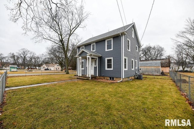 view of front of house featuring central AC and a front yard