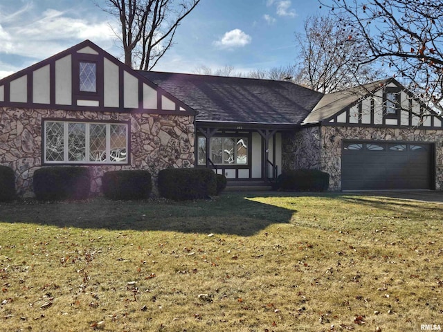 tudor-style house featuring a garage and a front lawn