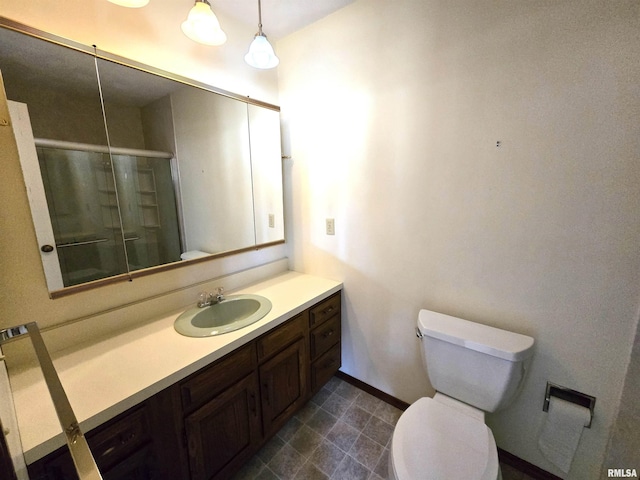 bathroom with an enclosed shower, vanity, and toilet