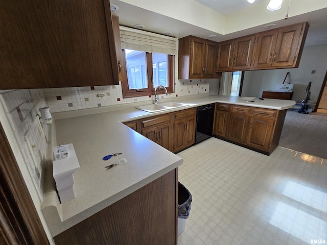 kitchen with sink, backsplash, kitchen peninsula, and dishwasher