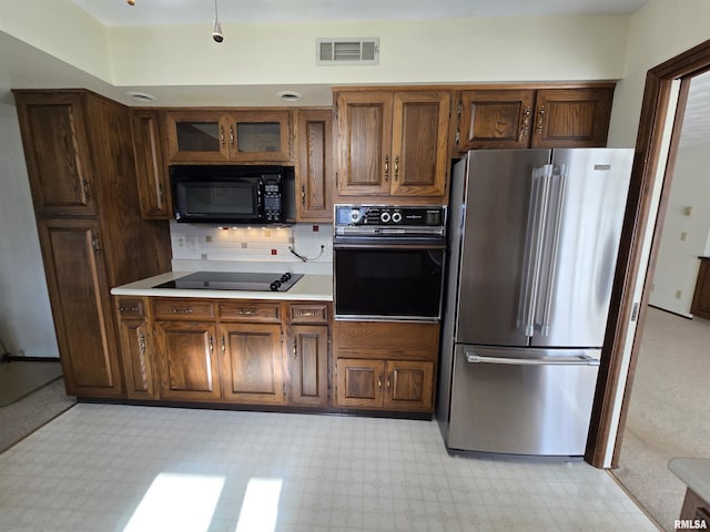 kitchen featuring decorative backsplash and black appliances