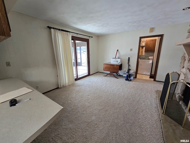 interior space with washer / clothes dryer and light colored carpet