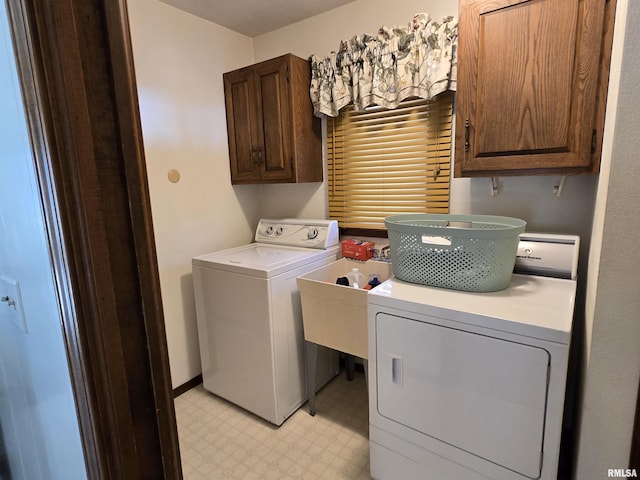 clothes washing area with independent washer and dryer and cabinets