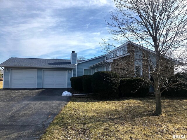 view of side of home featuring a garage