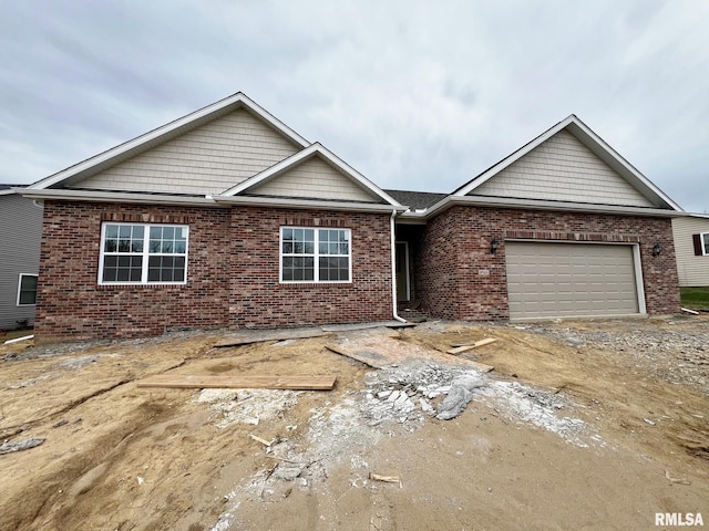 view of front facade with brick siding, driveway, and an attached garage